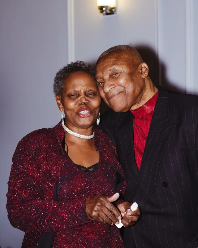 Two guests smiling together at a birthday celebration