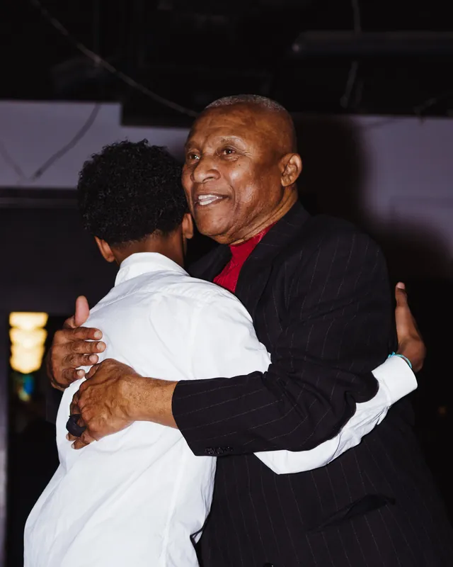 Two guests embracing at a celebration