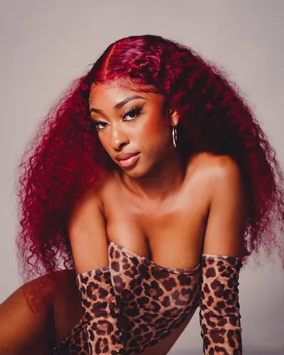 Portrait with red curls and a leopard-print outfit