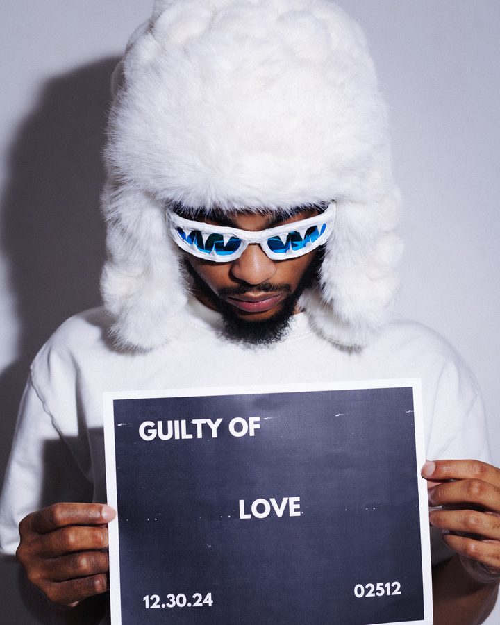Portrait holding a Guilty of Love placard