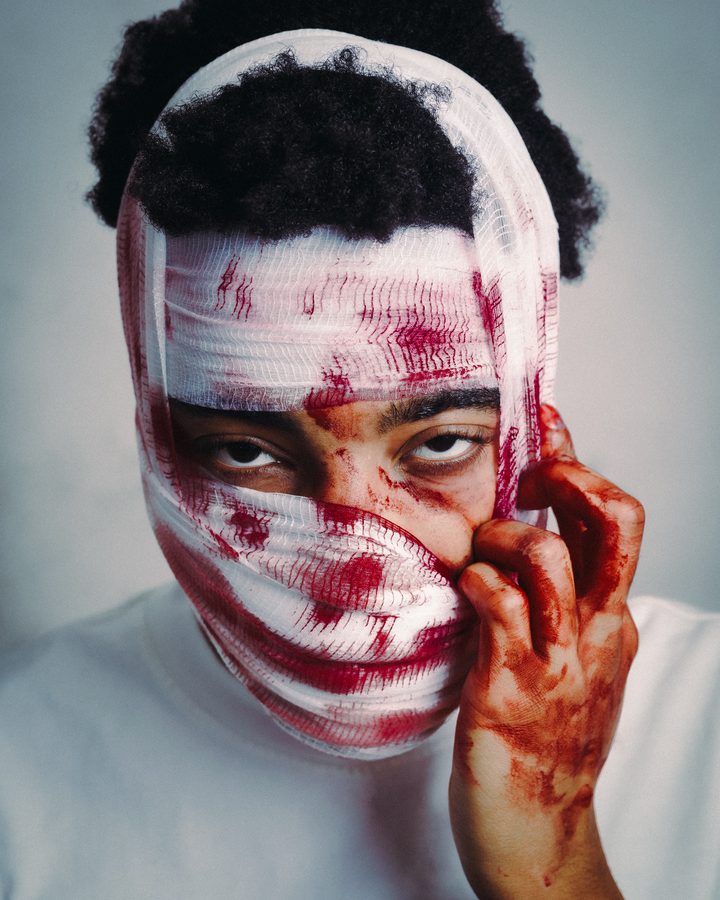 Portrait with a white bandage face covering
